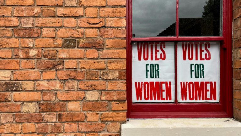 Vote to end sexism in schools - image of "Votes for Women" posters in a window.